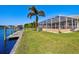 Peaceful canal-side view with lush lawn at 15912 Melport Cir, Port Charlotte, FL 33981