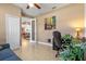 Home office with built-in desk and view into living area at 15912 Melport Cir, Port Charlotte, FL 33981