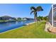 Serene waterfront property with dock and palm trees at 15912 Melport Cir, Port Charlotte, FL 33981