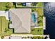 An aerial view showcasing a home's pool and canal-front location at 15912 Melport Cir, Port Charlotte, FL 33981