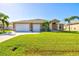 Single-story home with two-car garage and manicured lawn at 15912 Melport Cir, Port Charlotte, FL 33981