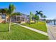 Landscaped backyard with pool and canal views at 15912 Melport Cir, Port Charlotte, FL 33981