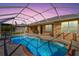 Inviting kidney-shaped pool with a screened enclosure at 15912 Melport Cir, Port Charlotte, FL 33981