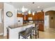 Modern kitchen with granite countertops, wood cabinets, and breakfast bar at 15912 Melport Cir, Port Charlotte, FL 33981
