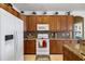 Well-equipped kitchen featuring wood cabinets and granite countertops at 15912 Melport Cir, Port Charlotte, FL 33981