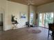 Living room with wood-look floors, access to a patio, and a ceiling fan at 5114 60Th E Dr, Bradenton, FL 34203