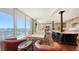 Bright living room with hardwood floors, access to balcony, and water views at 1233 N Gulfstream Ave # 1001, Sarasota, FL 34236
