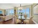 Bright dining area with glass table and chairs, overlooking the water at 1233 N Gulfstream Ave # 1001, Sarasota, FL 34236