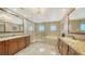 Spa-like bathroom with double vanity, soaking tub and walk-in shower at 1233 N Gulfstream Ave # 1001, Sarasota, FL 34236