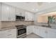 Renovated kitchen, featuring white shaker cabinets, granite counters, and stainless steel appliances at 6101 34Th W St # 15B, Bradenton, FL 34210