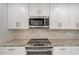Modern kitchen with white cabinets, granite countertops, and stainless steel appliances at 6101 34Th W St # 15B, Bradenton, FL 34210