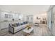 Open-concept living space with light flooring, contemporary furniture, and a view of dining area at 6101 34Th W St # 15B, Bradenton, FL 34210