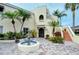 Mediterranean-style building with courtyard fountain, inviting entryway, and lush landscaping at 6101 34Th W St # 15B, Bradenton, FL 34210