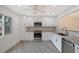Renovated kitchen, featuring white shaker cabinets, granite counters, and stainless steel appliances at 6101 34Th W St # 15B, Bradenton, FL 34210