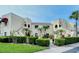 Two-story building with stucco exterior, featuring manicured landscaping and a welcoming entrance at 6101 34Th W St # 15B, Bradenton, FL 34210