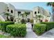 Two-story building with stucco exterior, featuring manicured landscaping and a welcoming entrance at 6101 34Th W St # 15B, Bradenton, FL 34210