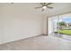 Bright bedroom with neutral walls, carpet flooring, and sliding doors to patio at 11722 Bluebird Pl, Bradenton, FL 34211