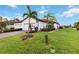 Single-story home with two-car garage and tropical landscaping at 11722 Bluebird Pl, Bradenton, FL 34211