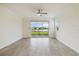 Living room with sliding doors leading to a backyard and water view at 11722 Bluebird Pl, Bradenton, FL 34211