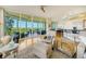 Relaxing living room with hardwood floors and access to a balcony with water views at 393 N Point Rd # 801, Osprey, FL 34229