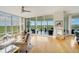 Spacious living room with hardwood floors,water views, and access to a balcony at 393 N Point Rd # 801, Osprey, FL 34229