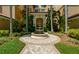 Elegant courtyard entry with fountain and landscaping at 393 N Point Rd # 801, Osprey, FL 34229
