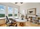 Home office with stunning views, built-in shelving and a large desk at 393 N Point Rd # 801, Osprey, FL 34229