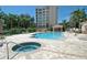 Resort-style pool and spa with a hot tub, surrounded by lush landscaping at 393 N Point Rd # 801, Osprey, FL 34229