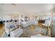 Open concept living room with hardwood floors, neutral decor, and access to kitchen at 393 N Point Rd # 801, Osprey, FL 34229