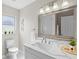 Bright bathroom with modern vanity, updated fixtures, decorative mirror, and plenty of natural light at 1012 Myrtle Ave, Venice, FL 34285