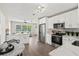 Bright, modern kitchen featuring white cabinets, stainless steel appliances, and sleek marble countertops at 1012 Myrtle Ave, Venice, FL 34285