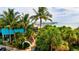 Captivating view of the pier framed by lush palm trees and tropical foliage, offering a serene beach setting at 1012 Myrtle Ave, Venice, FL 34285