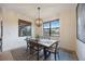 Bright dining room featuring a wood table and large windows at 10141 Fiddlewood Dr, Venice, FL 34293