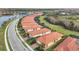 Aerial view of a community with houses featuring red tile roofs and lush landscaping at 10141 Fiddlewood Dr, Venice, FL 34293