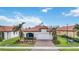 One-story home with terracotta tile roof, white garage door, and landscaped front yard at 10141 Fiddlewood Dr, Venice, FL 34293