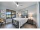 Bedroom with a bed, nightstands, and window overlooking a golf course at 10141 Fiddlewood Dr, Venice, FL 34293