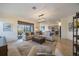 Open living room featuring plush sofas, a large area rug, and views into the kitchen at 10141 Fiddlewood Dr, Venice, FL 34293