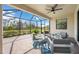 Spacious screened patio with seating area and backyard views at 10141 Fiddlewood Dr, Venice, FL 34293