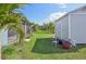 View of the backyard, including a shed and patio furniture at 11213 Gulfstream Blvd, Port Charlotte, FL 33981