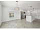 Open dining area adjacent to kitchen, featuring large window and modern lighting at 11213 Gulfstream Blvd, Port Charlotte, FL 33981
