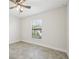 Bright bedroom featuring ceiling fan and tile floors at 11213 Gulfstream Blvd, Port Charlotte, FL 33981