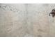 Walk-in shower with pebble tile flooring and neutral tile at 11213 Gulfstream Blvd, Port Charlotte, FL 33981