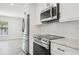Stainless steel appliances and white cabinets in a modern kitchen at 11213 Gulfstream Blvd, Port Charlotte, FL 33981