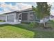 Single story home with gray exterior and screened porch at 11213 Gulfstream Blvd, Port Charlotte, FL 33981