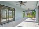 Bright screened porch featuring sliding glass doors and ceiling fans at 11213 Gulfstream Blvd, Port Charlotte, FL 33981