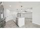 Modern kitchen with white cabinets, a large island, and stainless steel appliances at 11213 Gulfstream Blvd, Port Charlotte, FL 33981