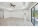 Open living area with tile floors and access to the back patio at 11213 Gulfstream Blvd, Port Charlotte, FL 33981
