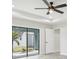 Main bedroom with sliding glass doors and a ceiling fan at 11213 Gulfstream Blvd, Port Charlotte, FL 33981