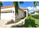 Front entrance of the house with a walkway and lush landscaping at 3924 Alamanda Dr, Sarasota, FL 34238