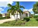 Well-maintained house with a landscaped lawn, paved driveway, and two-car garage at 3924 Alamanda Dr, Sarasota, FL 34238